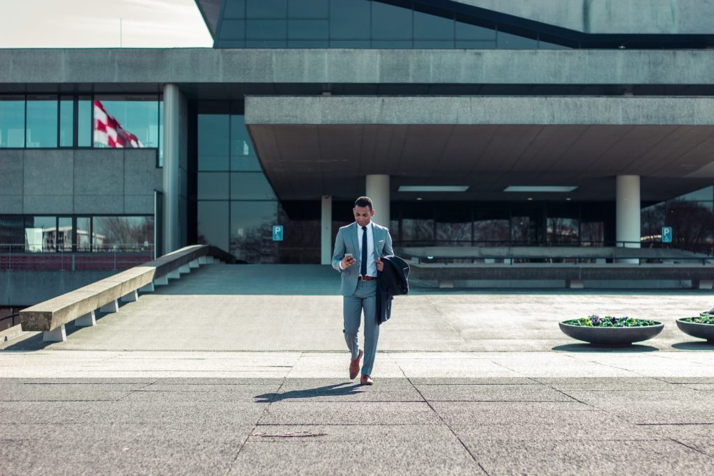 Man in suit_walkingout_Building